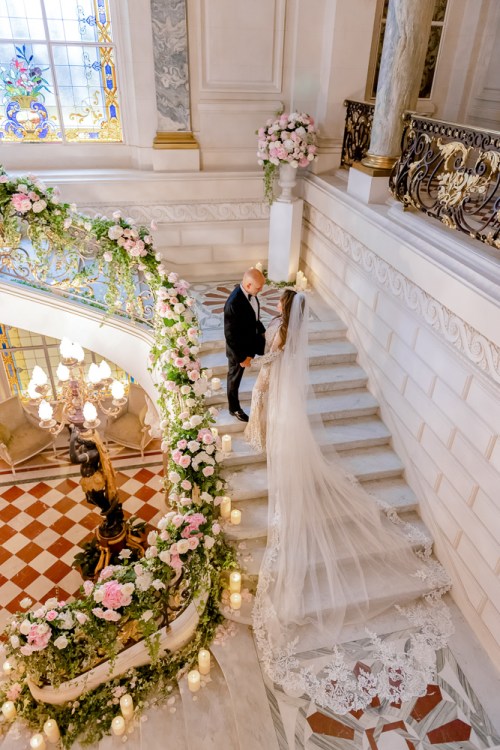 Bride and groom posing for pictures in Shangri La Paris