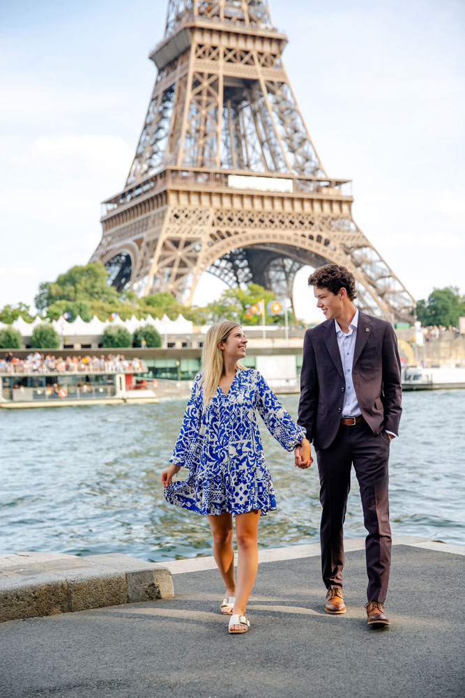 Walking hand in hand along Seine River after a marriage proposal