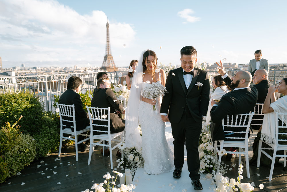 Couple at the end of an elopement ceremony, on a Paris rooftop