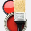 black brush with red paint on can with red lid
